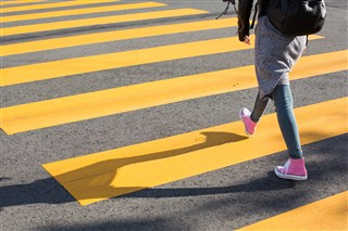 girl-crossing-street-on-a-yellow-crosswalk-picjumb